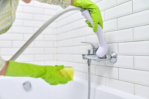 Bathroom fixtures being cleaned and polished